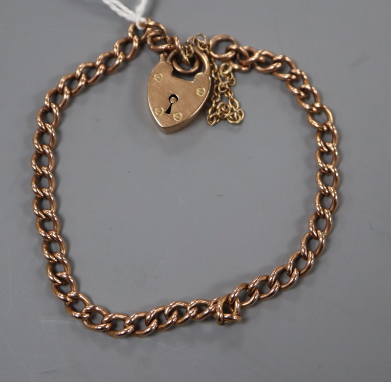 An early 20th century 9ct curblink bracelet with heart shaped clasp, gross 10.8 grams.